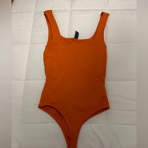 Orange body suit
